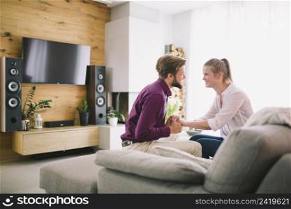 couple holding hands couch