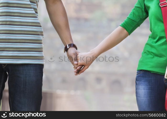 Couple holding hands in a park