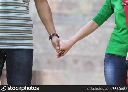 Couple holding hands in a park