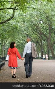 Couple holding hands in the park
