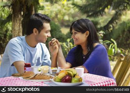 Couple holding hands on breakfast table