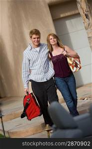 Couple Holding Luggage