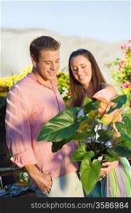 Couple Holding Potted Plant