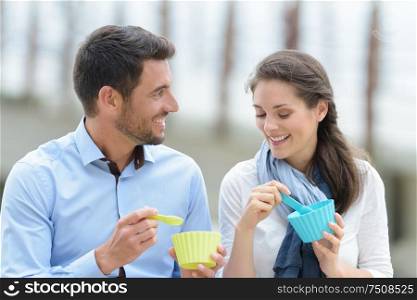 couple holding silicon cups