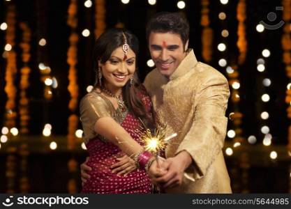 Couple holding sparkler