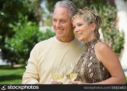 Couple holding wine outdoors
