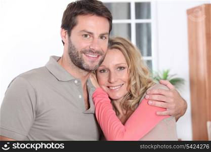 Couple hugging at home