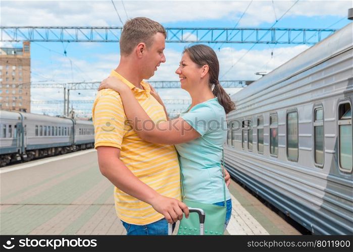 Couple hugging at the train station after a long separation