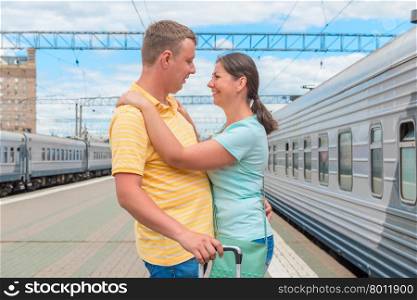 Couple hugging at the train station after a long separation