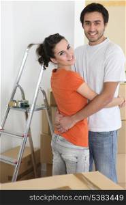 Couple hugging by ladder