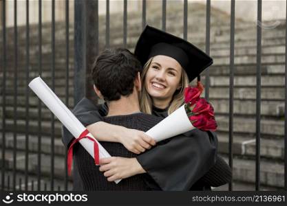 couple hugging graduation