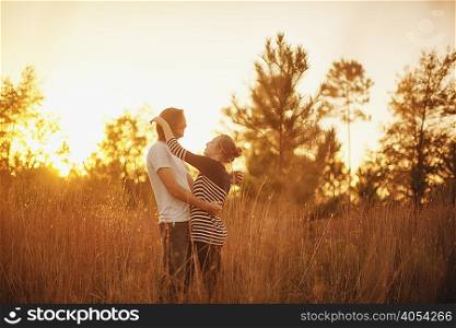Couple hugging in field