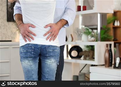 Couple hugging in front room