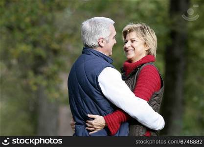 Couple hugging in park