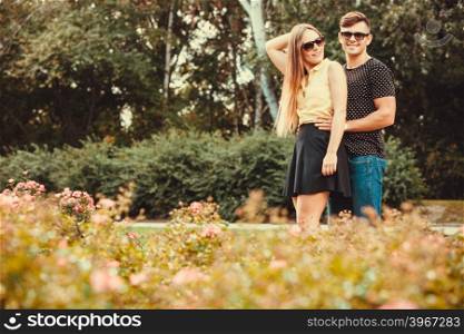 Couple hugging in park. . Love romance relationship dating leisure concept. Couple hugging in park. Young girlfriend with her man together holding hands.