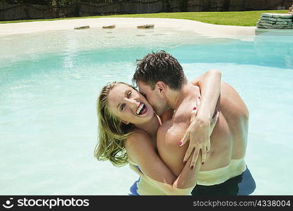 Couple hugging in swimming pool