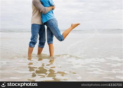 Couple hugging in the sea