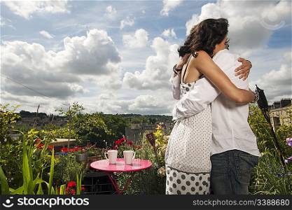 couple hugging on balcony