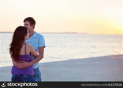 Couple hugging on pier outdoors