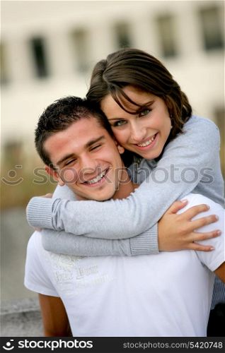 Couple hugging outside building