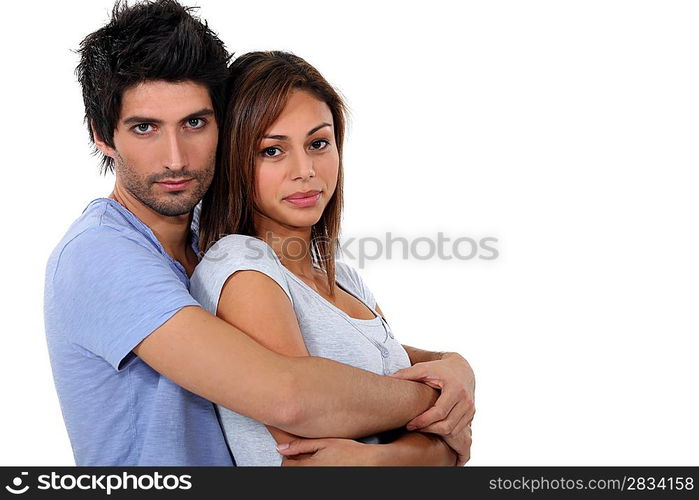 Couple hugging, studio shot