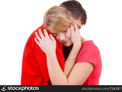 Couple hugging. Woman is sad and being consoled by his partner. Man comforting his girlfriend. Troubled girl and her boyfriend. Studio shot on white . Couple. Woman is sad and being consoled by his partner