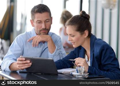 couple in a bar using a digital tablet
