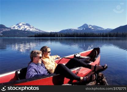Couple in a Canoe Resting and Checking Out the Scenery