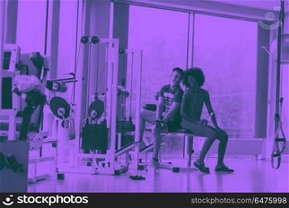 couple in a gym have break. healthy couple have break at crossfit gym african american woman with afro hairstyle duo tone filter