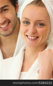 Couple in bath robes getting ready