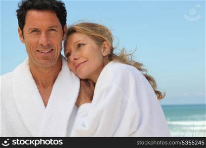 couple in bathrobes on the beach