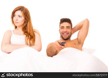Couple in bed - Man is watching television and woman doesn&rsquo;t like it