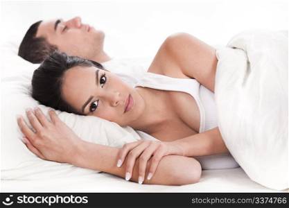 Couple in bed, men sleeping and woman lying sleepless in white background