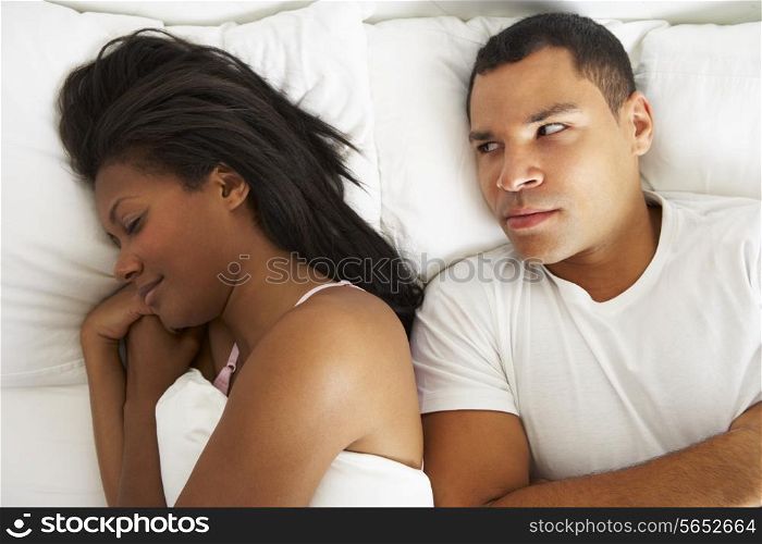 Couple In Bed With Relationship Difficulties