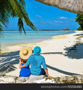 Couple in blue clothes on a tropical beach at Maldives