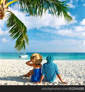 Couple in blue clothes on a tropical beach at Maldives