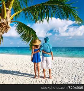 Couple in blue clothes on a tropical beach at Maldives