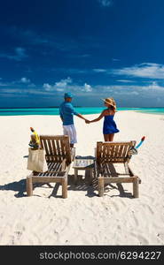 Couple in blue on a tropical beach at Maldives