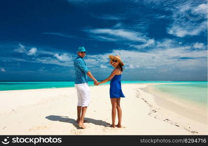 Couple in blue on a tropical beach at Maldives