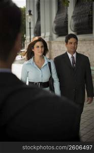 Couple in business clothes walking outdoors