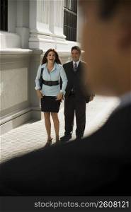 Couple in business clothes walking outdoors
