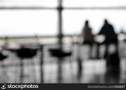 Couple in cafe in airport out of focus