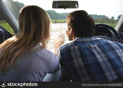 Couple in car map reading preparing for walk