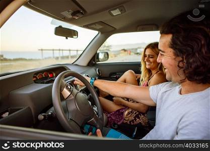 Couple in car on journey, smiling