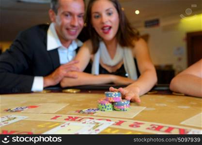 Couple in casino placing chips
