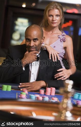 Couple in casino playing roulette (selective focus)