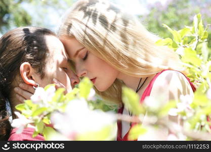 Couple in cherry tree flowers. Soft focus effect.