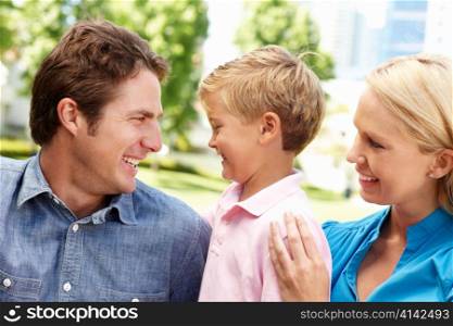 Couple in city park with young son