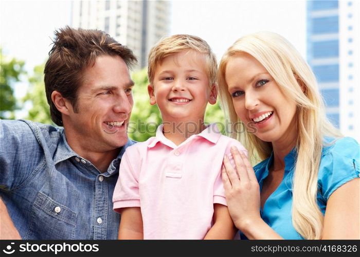 Couple in city park with young son