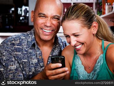 Couple in Coffee House with Cell Phone
